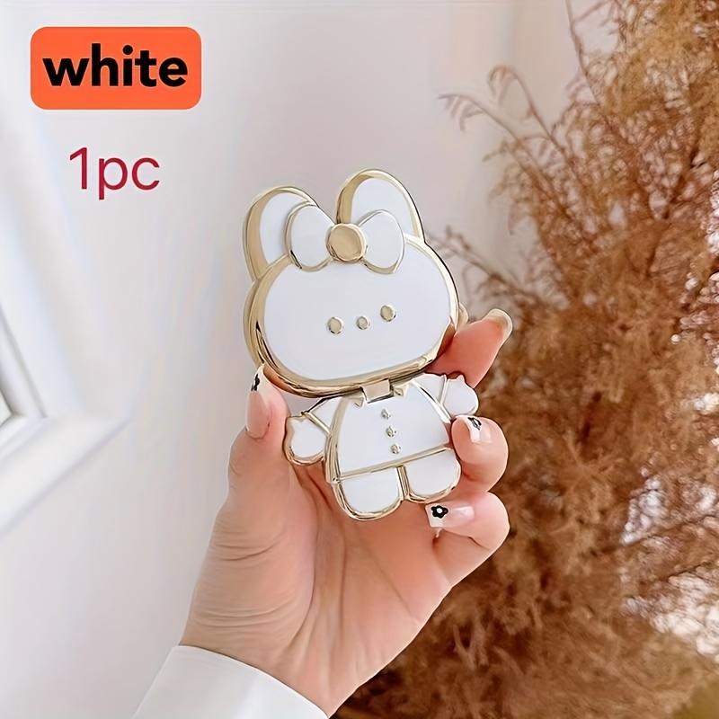 New rabbit-shaped adhesive phone stand with makeup mirror is suitable for iPhone, Samsung, Xiaomi phones, and various other phones. The rabbit phone case desktop stand is a hollow-out lazy stand