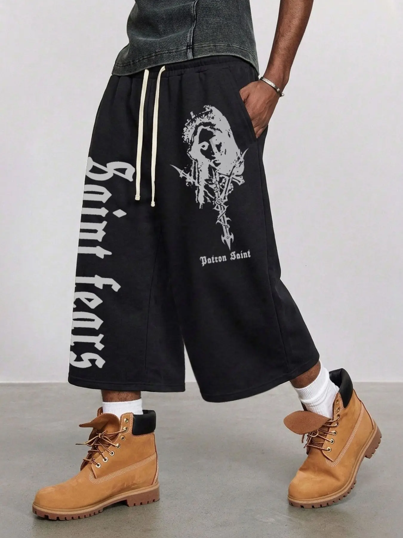 Men Punk Vintage Capri Sweat Pants Solid Black Elastic High Waist Off White Dual Drawstring Vertical Gothic Letter & Distressed Saint Portrait Cross Print Oversized Wide Leg 7/8 Length French Terry Jogger Trousers Deep Side Pockets Hip Hop Skater Streetwe