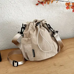 2026 Spring nylon casual messenger bag women's fashion drawstring bundle bucket bag going out versatile mobile phone bag, functional wind bundle bucket bag, large-capacity wear-resistant nylon bag, student party class one-shoulder messenger handbag