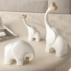Aris & Juno 3-Piece Elephant Family Statue with Heart Trunk - Resin Home Decor, Housewarming Gift desk staff