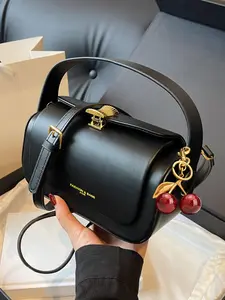 Retro light luxury texture simple and atmospheric flip bag, with cherry pendant design, fashionable and versatile personalized single shoulder crossbody bag, suitable for daily commuting and friend gatherings