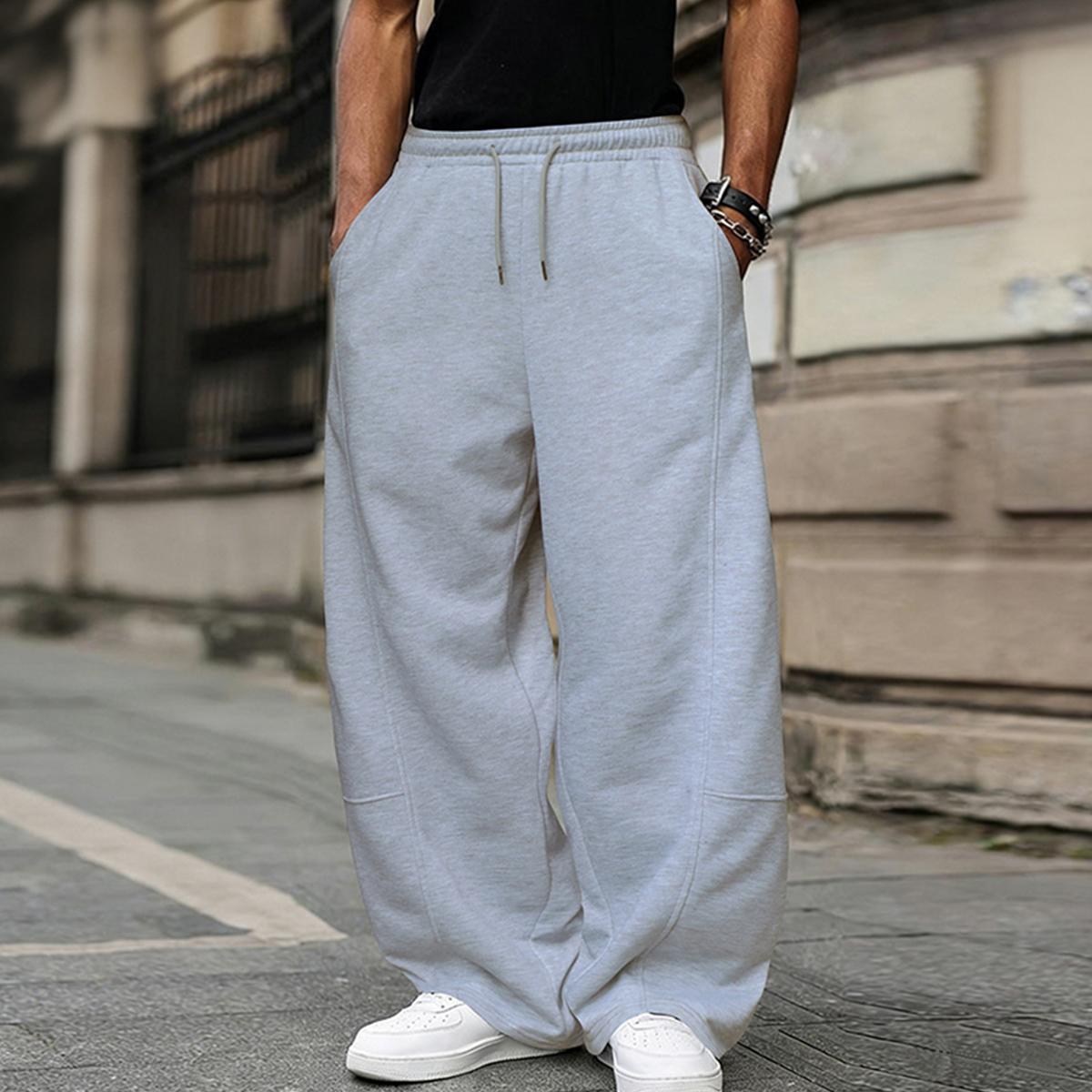 Men's solid color casual pants with an adjustable drawstring waistband. Stylish yet casual, comfortable and versatile, loose fit, suitable for all seasons, combining streetwear and sporty style