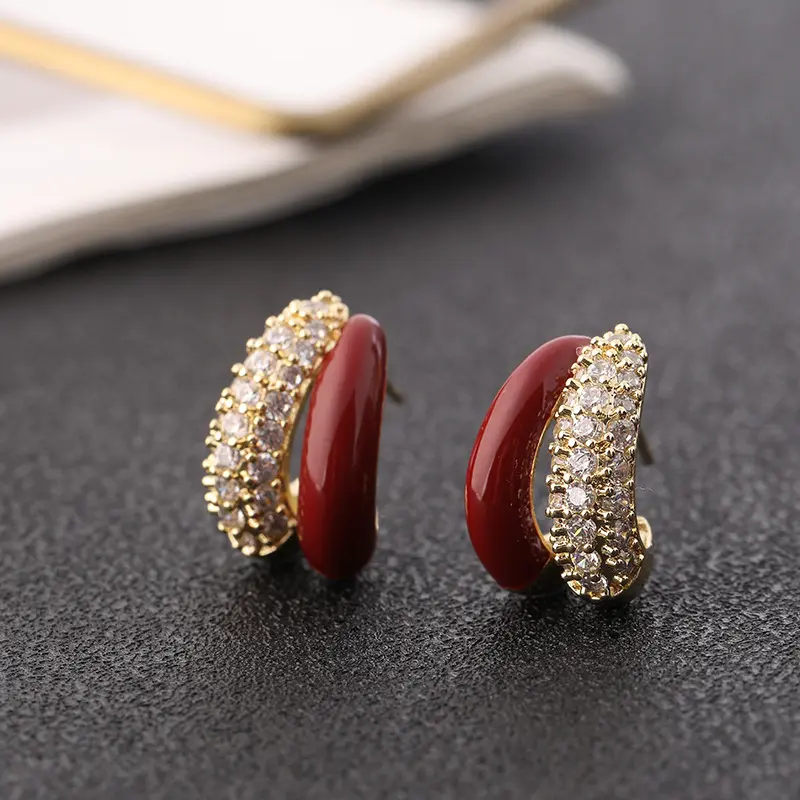 Chic Red Enamel Rhinestone Hoop Earrings for Women. Double-layer curved design combines glossy red enamel and full-paved sparkling crystals. Classic retro tone highlights elegant temperament. Lightweight structure, suitable for daily commuting, dating and