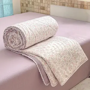 A pink purple floral print summer thin quilt with lace, an ultra soft and skin friendly air conditioning quilt and summer cooling quilt, suitable for summer bedrooms, offices, beds, living rooms, and home leisure use as a thin quilt