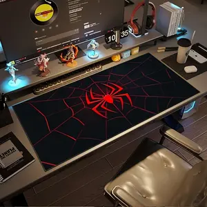 A Large Gaming Mouse Pad Featuring a Red And Black Spider Web Design with a Spider Hero Logo. It Is Non-Slip, Durable, And Has a Rubber Base, Making It a Great Addition to Any Office Desk. This Oversized Desk Mat Is Perfect for Computer Decoration A