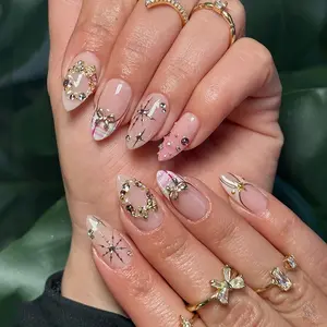 24 pcs of medium-length almond nails acrylic press on nails in nude pink and milky white gradient, featuring cute metal bow ties, rounded small pearls, colorful ribbons, plaid patterns, dreamy pink and white mixed designs, colorful rhinestones, Christmas
