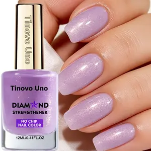 Tinovo Uno Diamond Strength Nail Polish, a light purple shade with glitter, resists chipping, dries quickly, and offers long-lasting shine with a subtle pearlescent finish. Suitable for all skin tones.