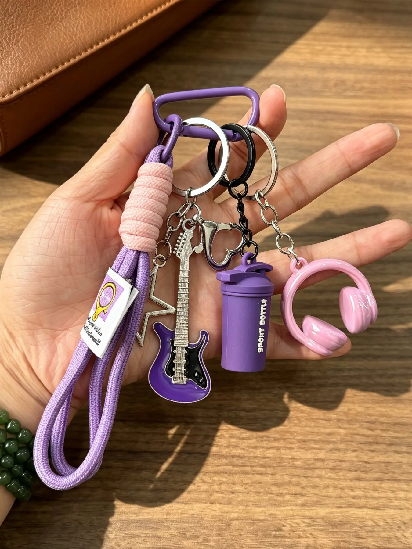 Y2K Rock Music Bag Charm Keychain in Black Purple, Complete Combo with Guitar, Star, Headphone & Mini Water Cup Charms. Equipped with braided wrist strap, fabric tag and matching lock carabiner, trendy backpack ornament for concert and band lovers