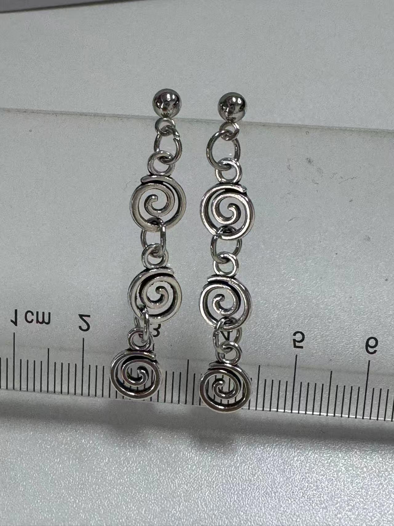 Vintage spiral earrings with distressed design, mosquito incense holder pendant, swirling long fringed earrings