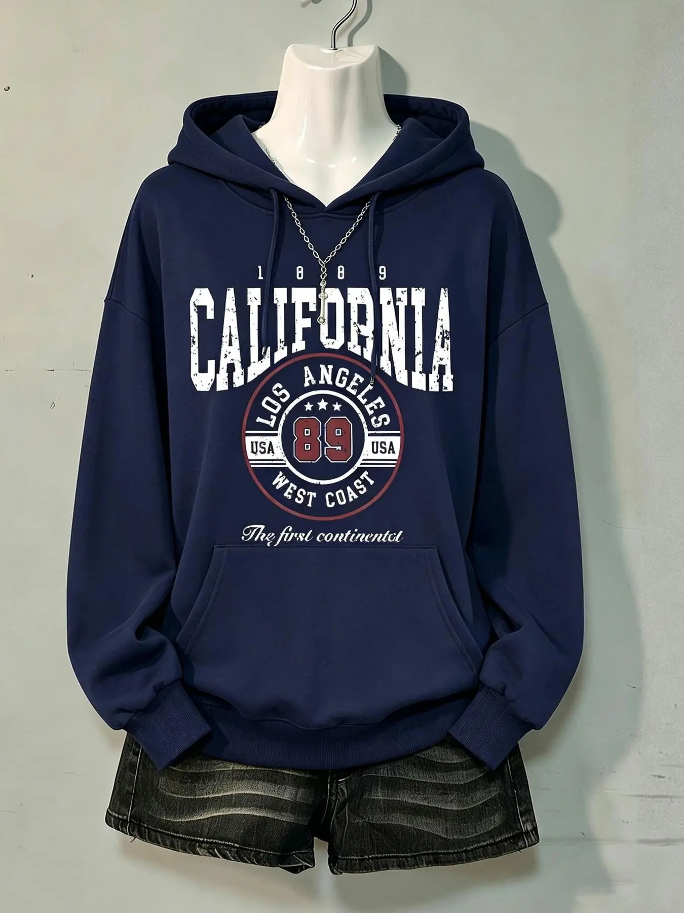 Women's loose-fit navy blue pullover hoodie featuring a vintage-style, distressed "California Los Angeles West Coast 89" graphic print—a relaxed, laid-back long-sleeve hooded sweatshirt.