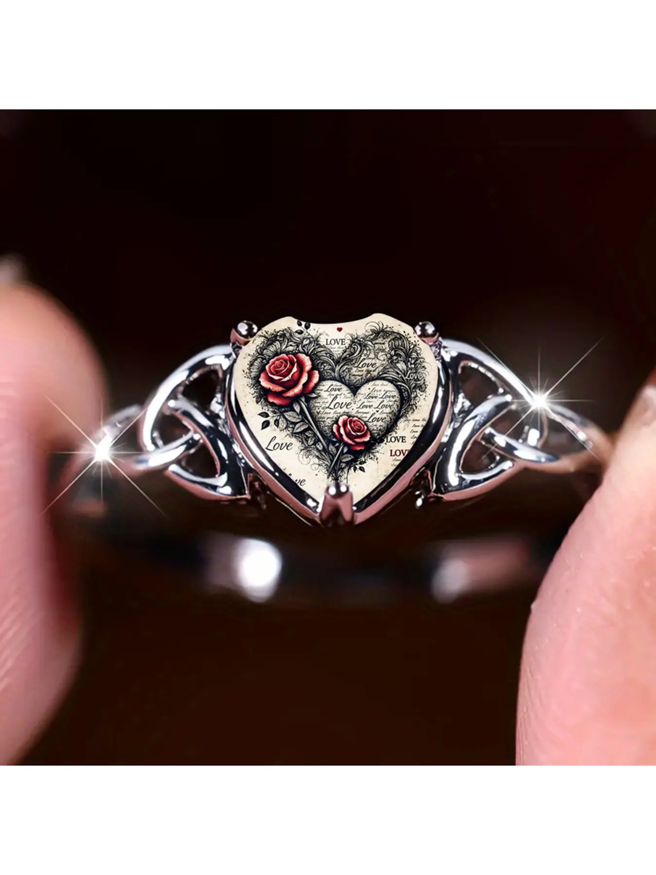 This ring is paired with a classic Celtic knot band. The heart-shaped embellishment features retro red roses and full-page expressions of love.