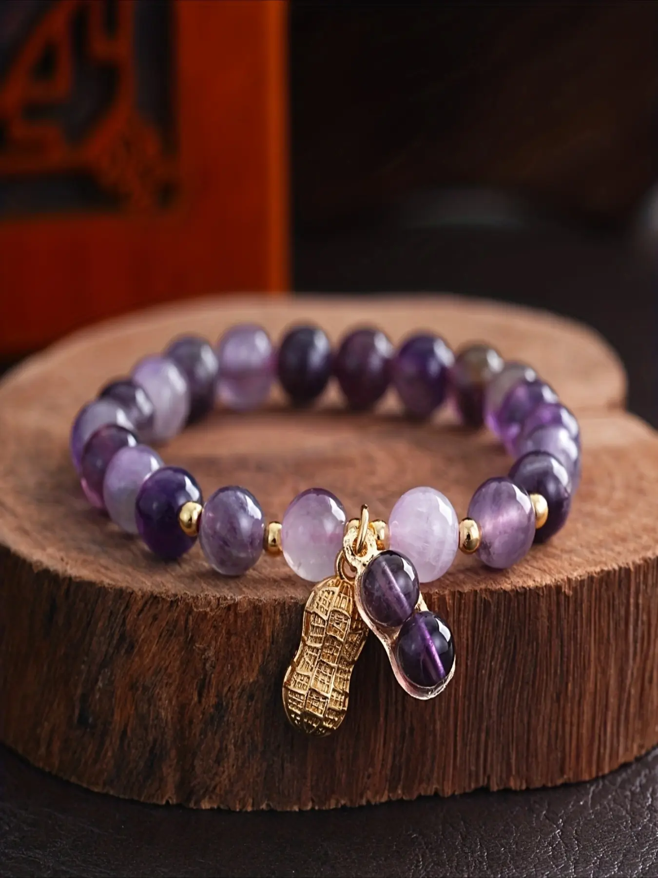 Amethyst Peanut Bracelet: An exquisite combination of dreamy amethyst and golden peanut ornaments. The Amethyst Peanut Bracelet is strung with dreamy amethyst beads.