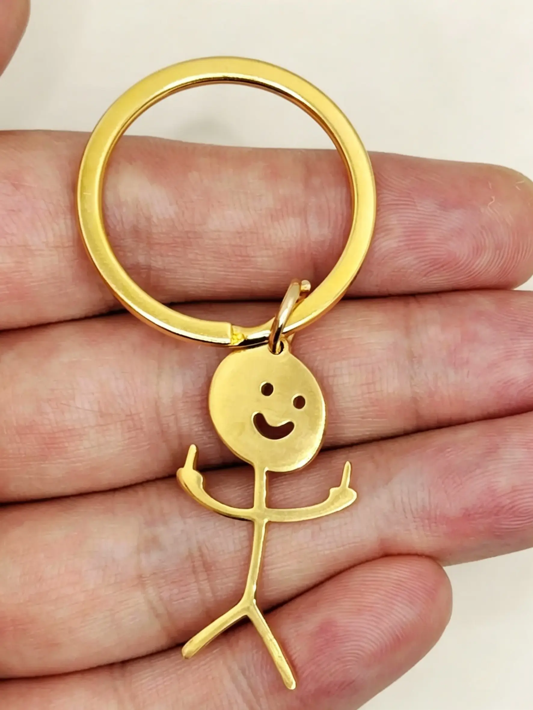 Funny Middle Finger Stick Figure Keychain, Novelty Stainless Steel Key Ring Charm. Viral funny mini stickman pendant, trendy gag gift for friends, classmates, coworkers. Lightweight portable bag accessory, unisex humor key ornament.