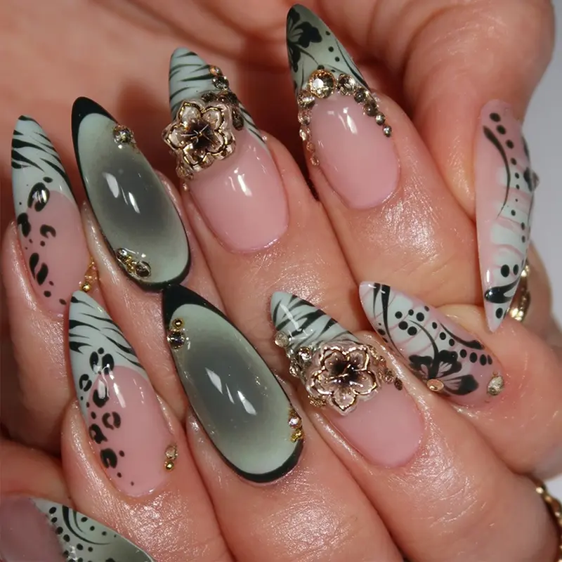 24 almond nails, Almond shape nails, with ink wash painting effect and metallic floral embellishments, rhinestone inlays, and a black, white, pink gradient base, creating a sexy style of fake nails suitable for women and girls for parties, photo shoots