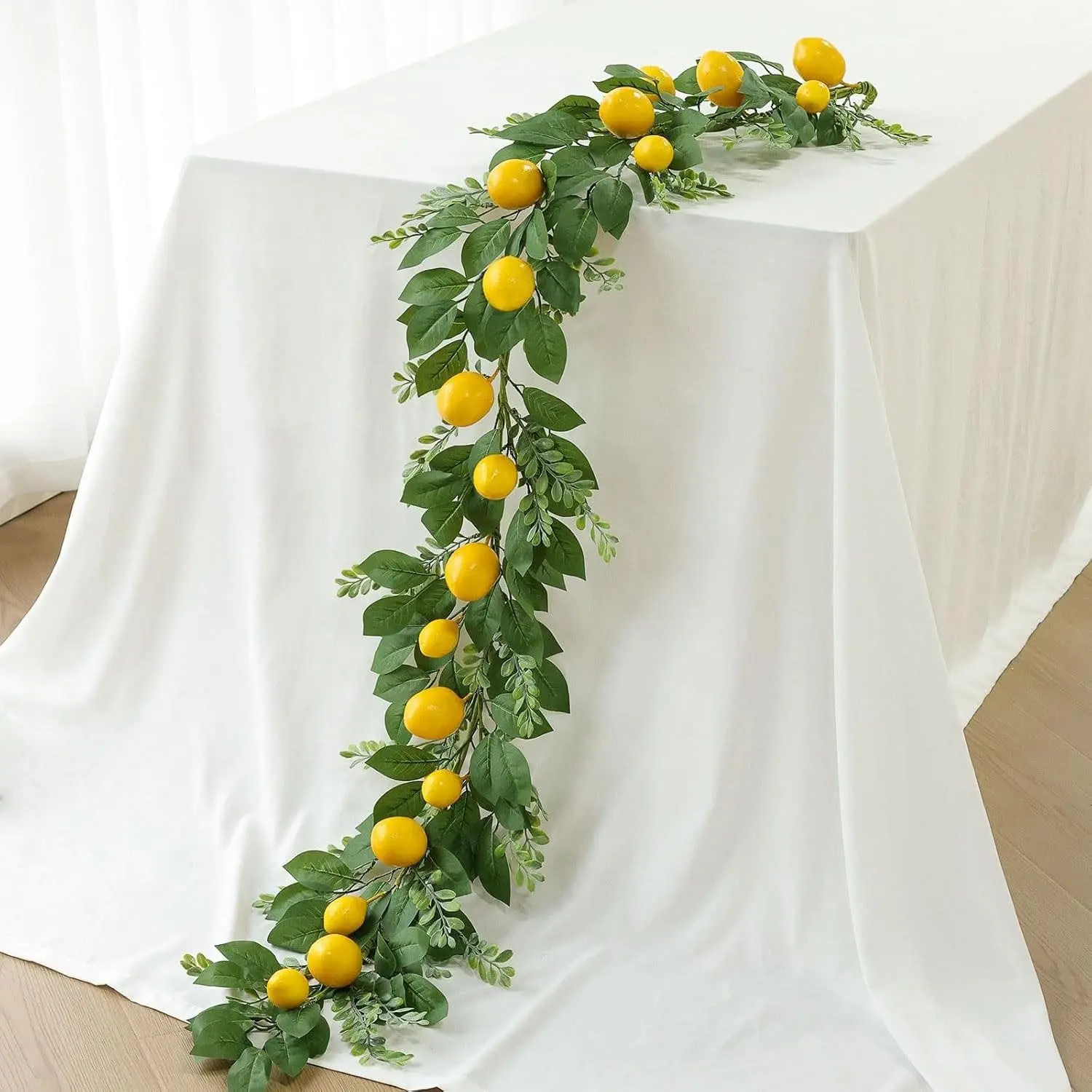 New artificial fruit lemon garland. Hanging vine. With green leaves. Green decoration. For center decoration of kitchen table, room walls, Halloween, Christmas parties, weddings, birthday decorations.