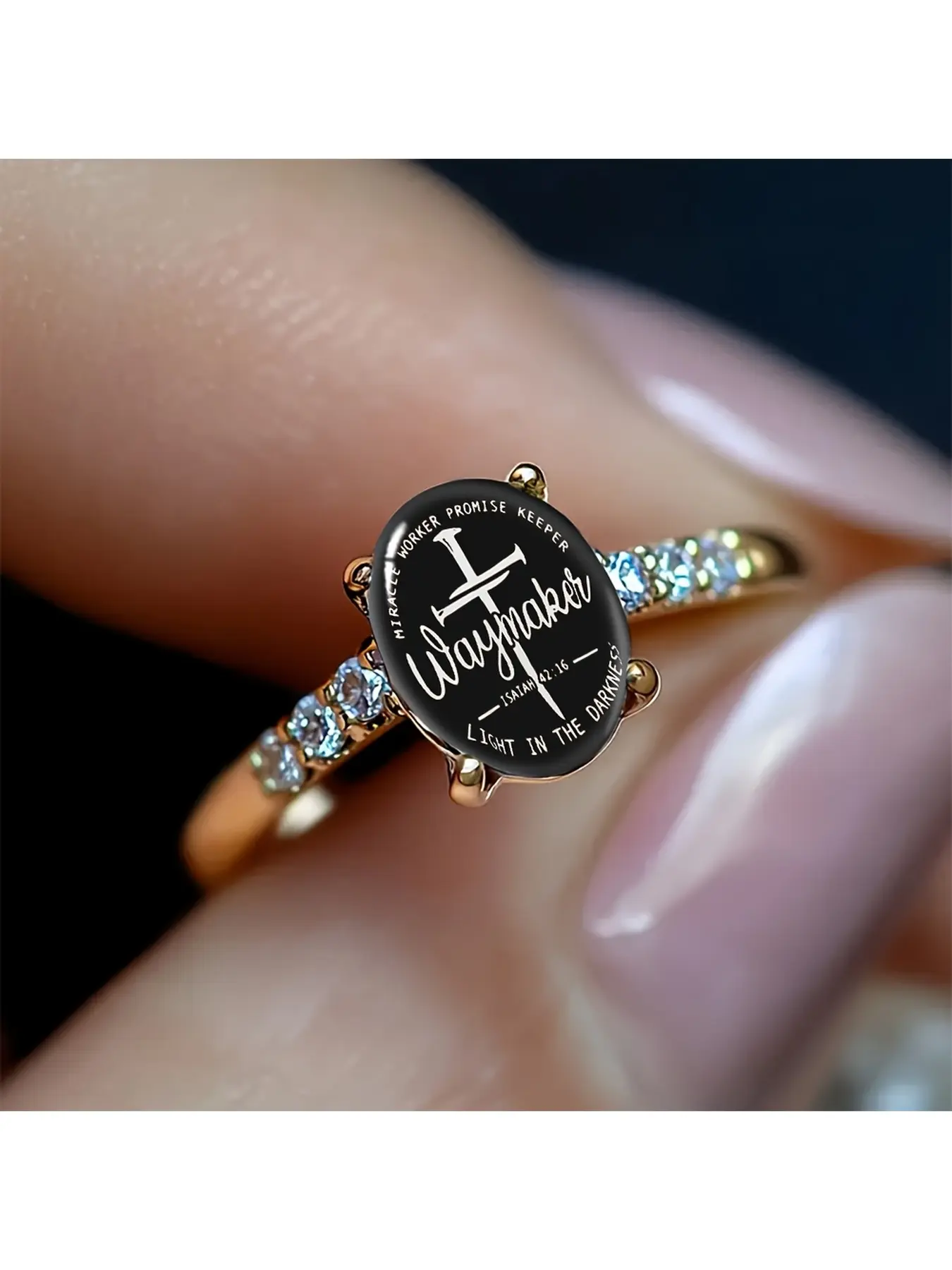 Black background scripture cross colored diamond gold ring, matte black background with white handwritten cross and Christian text, the central large handwritten word "Waymaker", the side features the scripture "Isaiah 42:16", the surrounding slogan "Mira