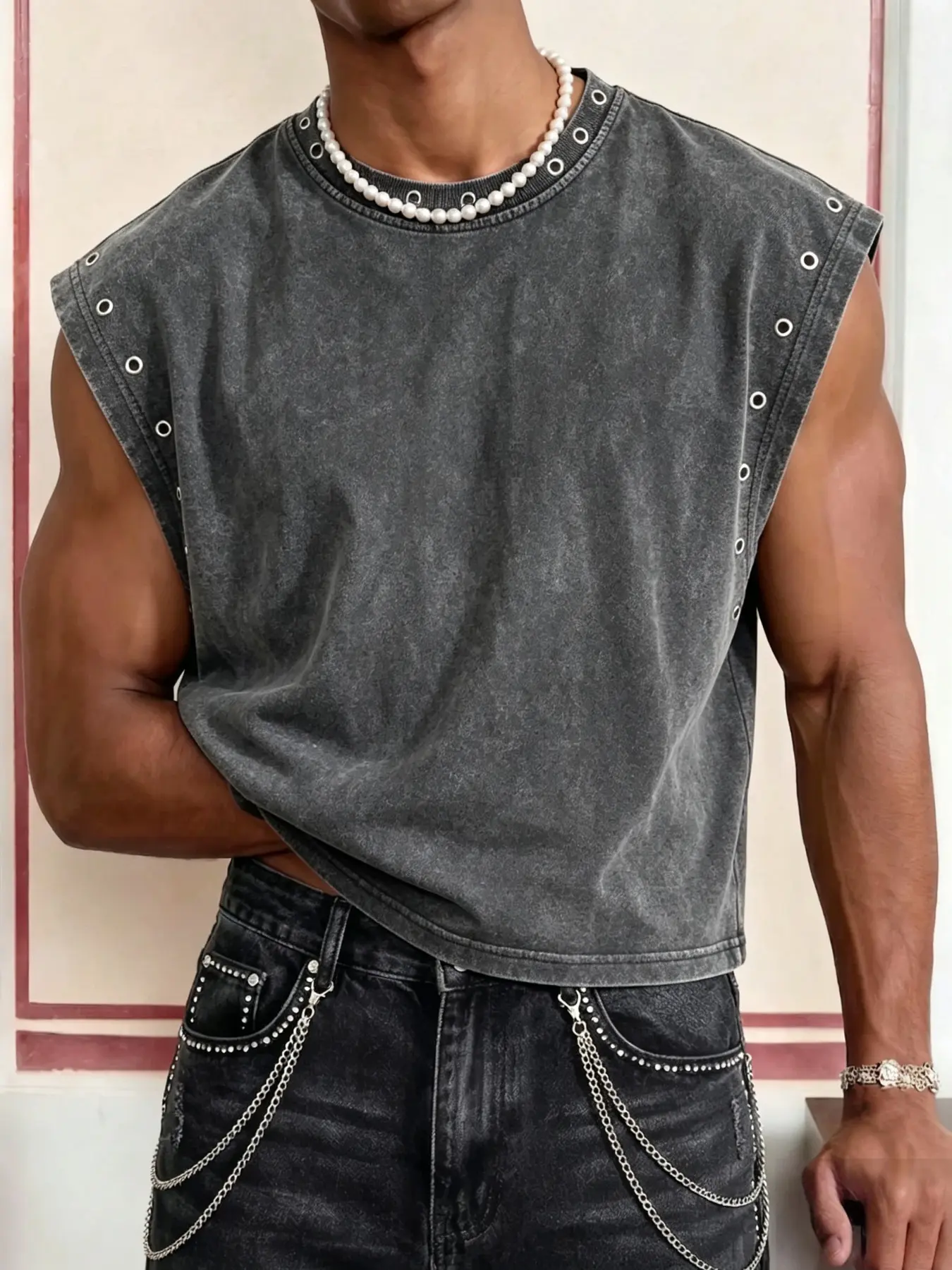 Men's washed-finish vest featuring eyelet detailing at the neckline and armholes; designed with a cropped fit and a minimalist, distinctive style, and crafted from cotton fabric for comfort and breathability.