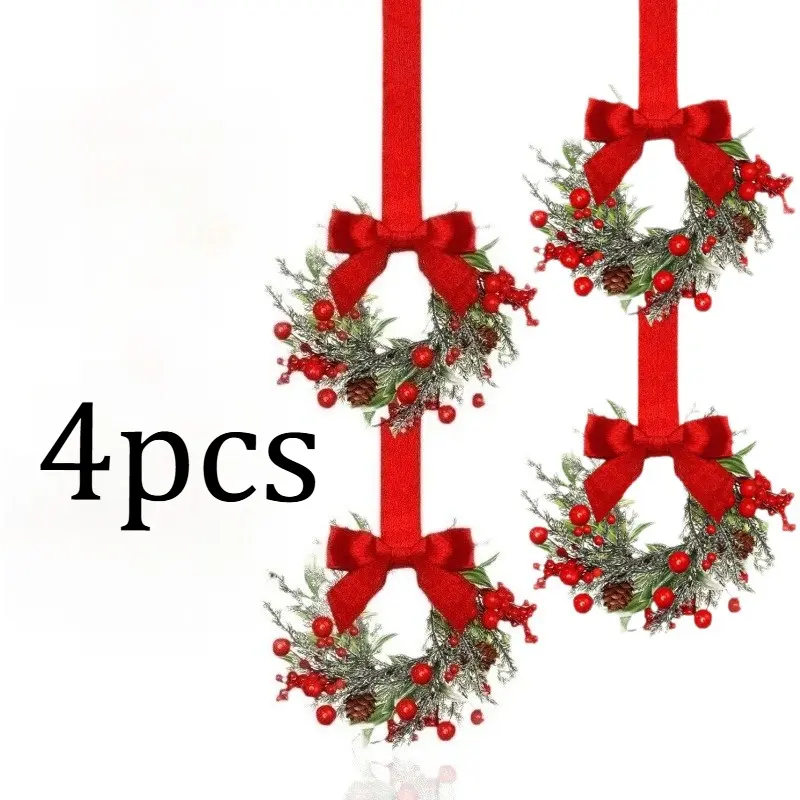 Four mini Christmas wreath ornaments, featuring a red velvet bow and faux frosted pine branches, berries, and small flowers, can be hung on front doors, cabinets, and windows for Christmas holiday decorations.