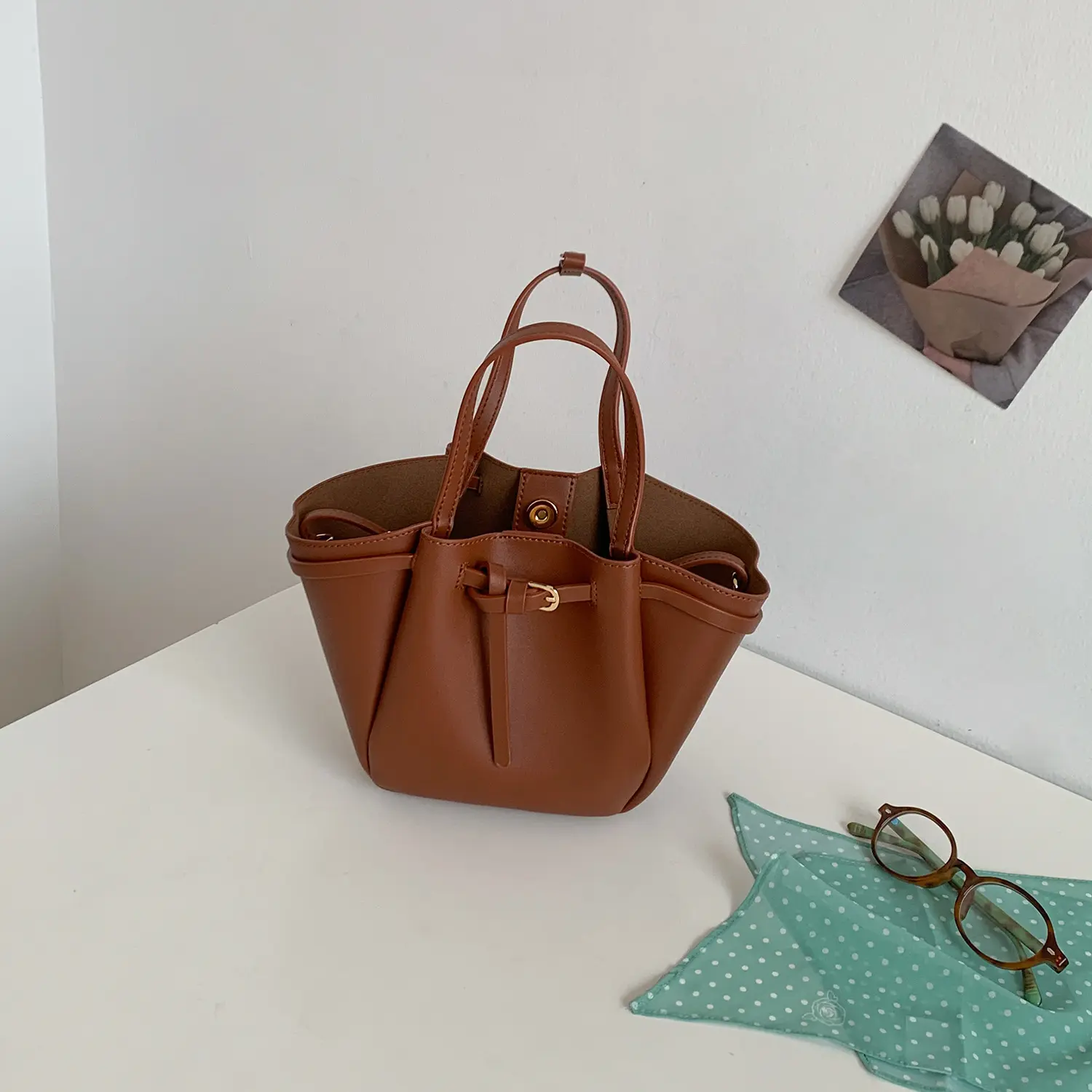 Women's leather crossbody bag; a minimalist tote featuring a bow-inspired "wing" design—a compact, elegant shoulder and handbag perfect for everyday shopping.