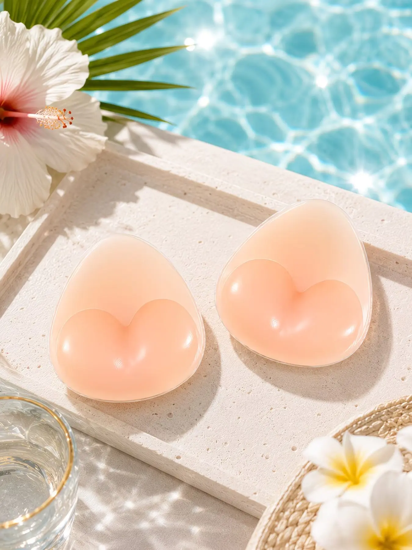 A pair of apricot-colored reusable silicone triangle bra pads, offering strong support, a seamless design, an invisible and close fit, high-quality materials, and coverage for nipple protrusions. These bra accessories are suitable for bikinis, swimsuits,