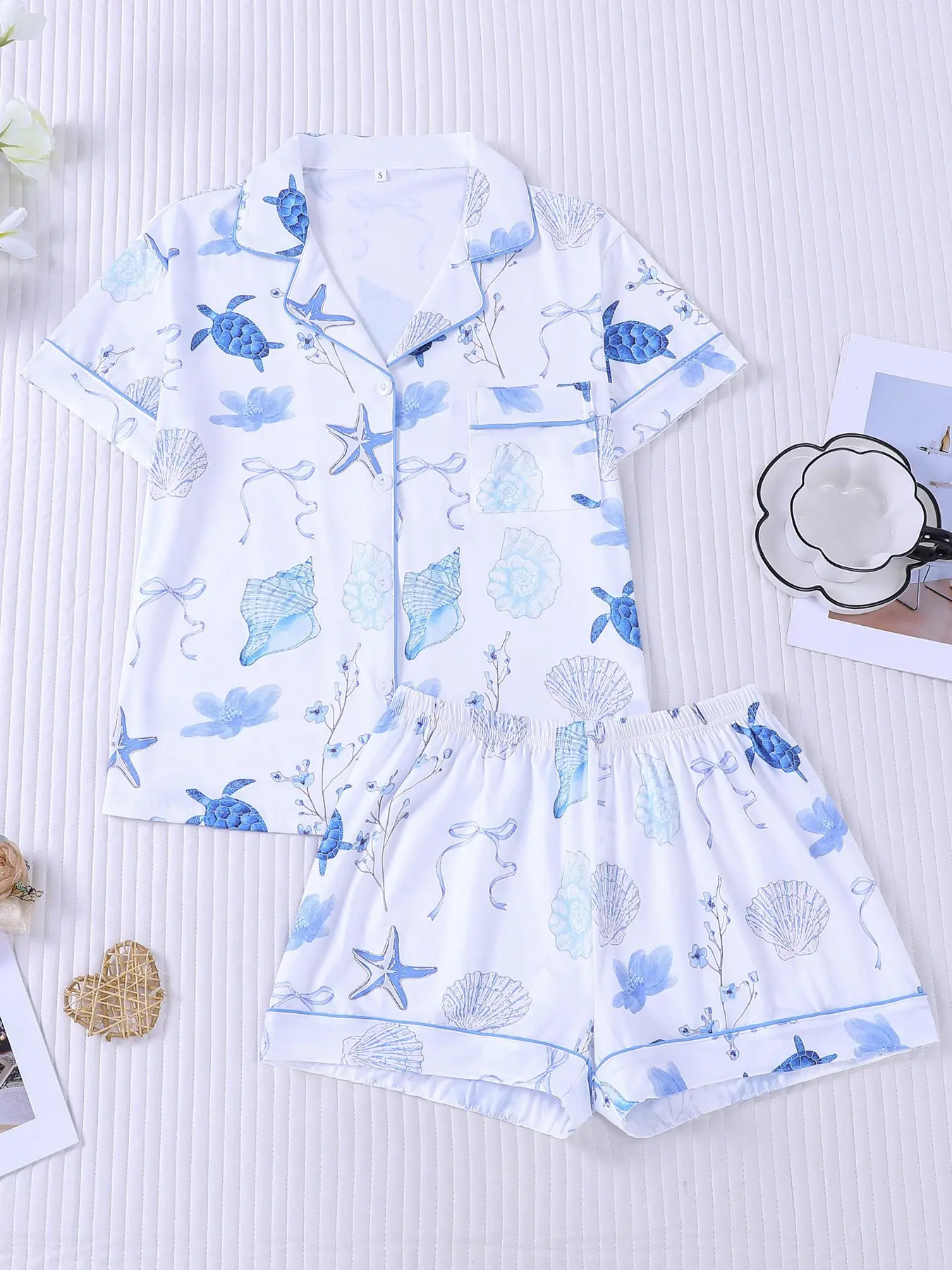 Women's 2-piece ocean pajama set, Collared pajama set, white base with blue turtle, starfish, seashell print, summer coastal vibe, light blue piping trim, Lapel top with pocket, soft elastic shorts, women casual loungewear, Casual summer sleepwear