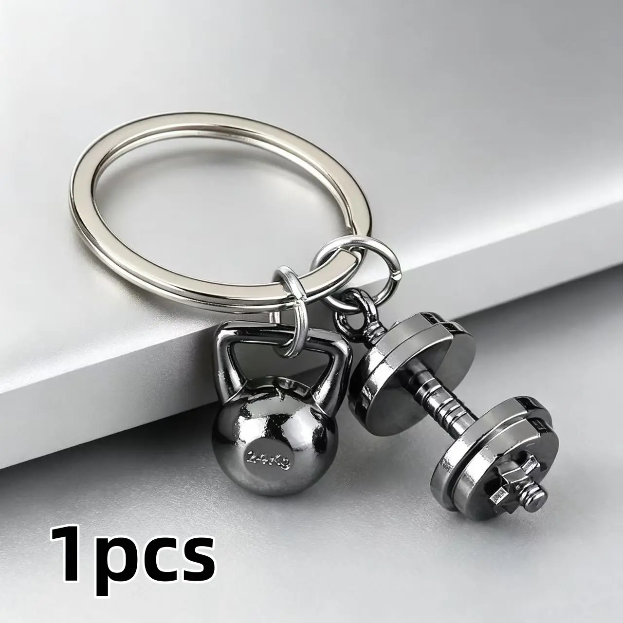 A creative alloy keychain in the shape of a dumbbell, resembling a sports accessory. It can be used as a decorative pendant for bags, or as a charming gift to give to friends.