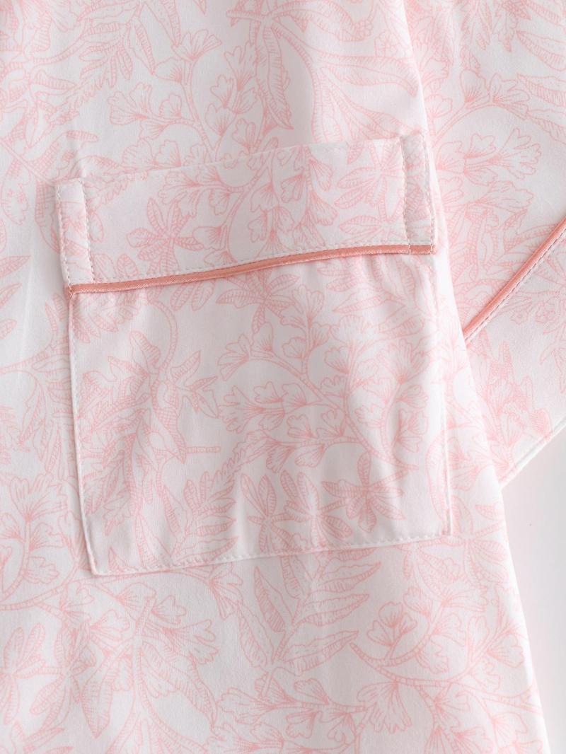 Two-piece pink ladies' pajama set with full-color prints. Button-front collar shirt and elastic waist pants pajama. Casual and comfortable collar long-sleeved top and long pants pajama set. Ladies' pajamas for spring and autumn.