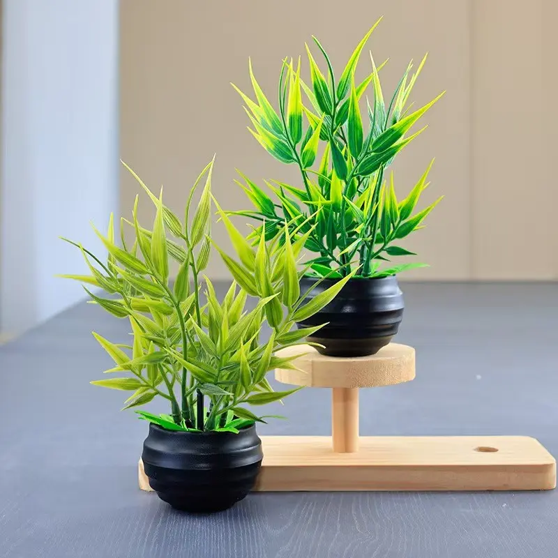 Two elegant artificial imitation bamboo leaves potted plants, with vivid and bright green leaves and black flower pots. They are suitable for decoration in home living rooms, bookshelves, bathrooms, offices. These are maintenance-free artificial plants. W