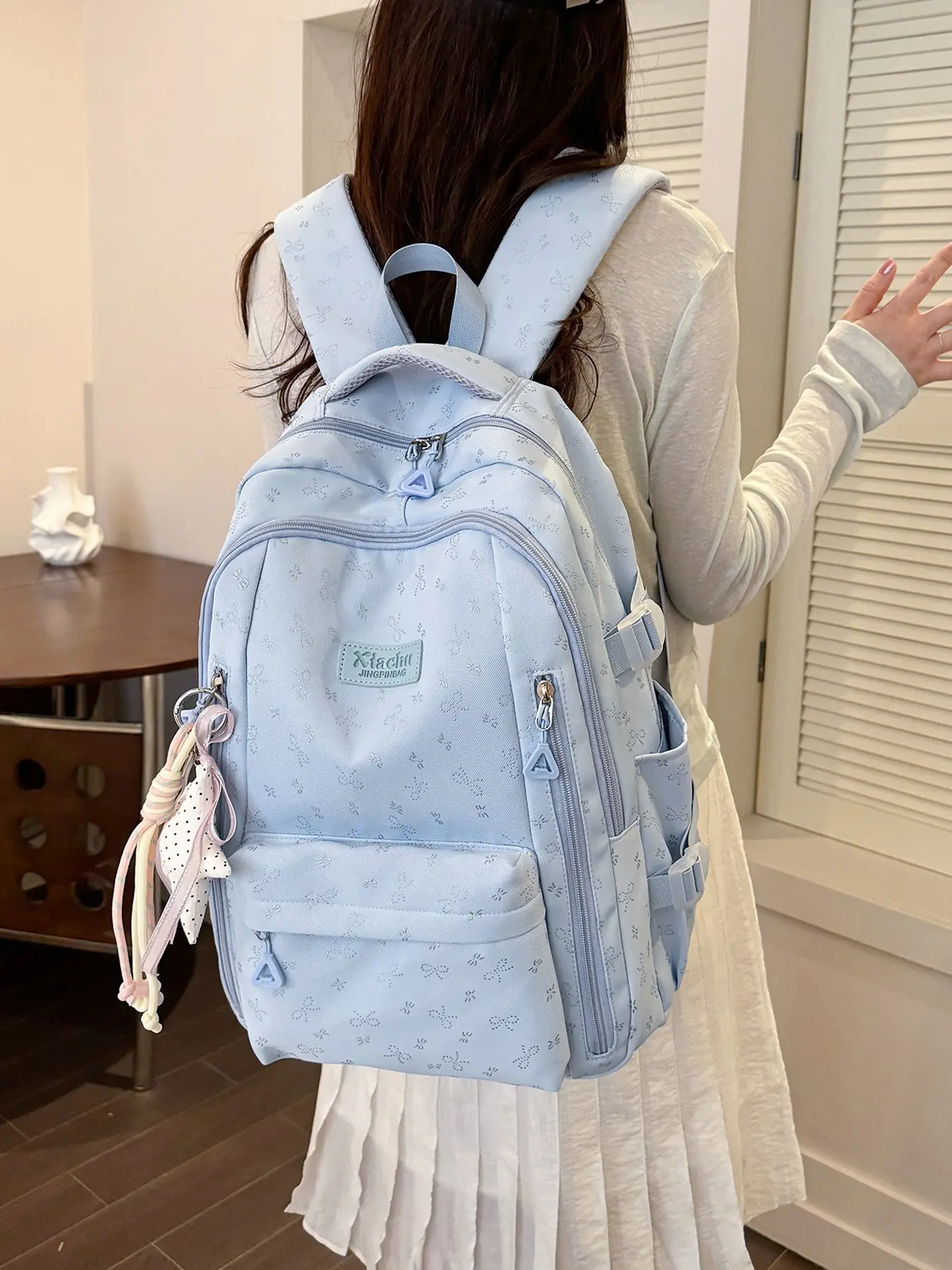 1pc Pale Light Blue Backpack With Tiny Hidden Bow Prints For Girls Fabric Leather Label Multi-layer Front Zipper Pockets Side Elastic Water Bottle Pocket Comes With Polka Dot Ribbon Charm Soft Wide Pressure-relief Straps Spacious School Rucksack For Teen