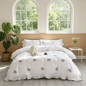 Three-piece princess-style bedding set featuring bow patterns and ruffled edges on duvet cover and pillowcases; duvet and pillow inserts not included.