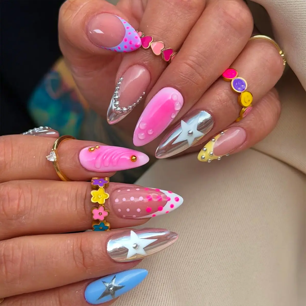 A set of 24pcs almond-shaped acrylic press-on nails, Decorative nails, featuring an "Ins-style" aesthetic with vibrant rainbow candy colors, this design combines pink polka-dot French tips with silver star-chain accents, Y2K Ins Style