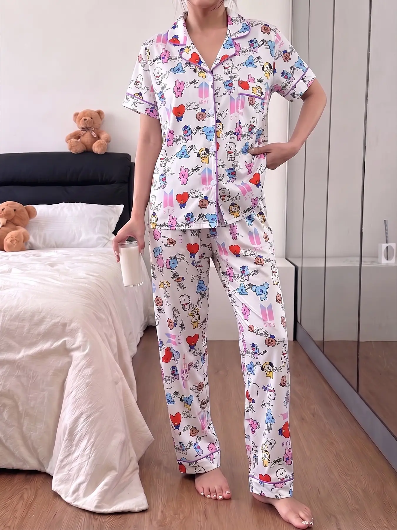 Women's 2-piece pajama set with cute BT21 cartoon, heart and signature print on white base, purple contrast piping. Lapel short sleeve top with chest pocket, soft elastic waist long pants, all-season casual home loungewear for women