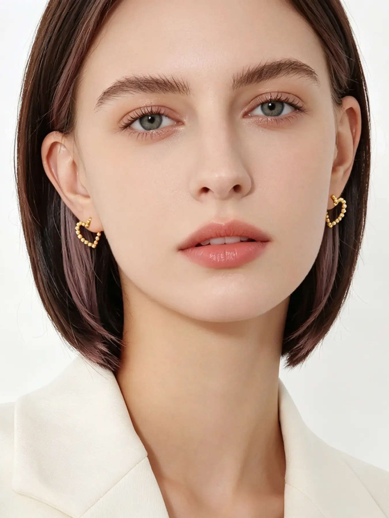 A pair of minimalist heart-shaped lacy earrings with smooth, delicate round beads, exuding a touch of playful charm. Perfect for daily commutes, dates, casual business settings, and more.