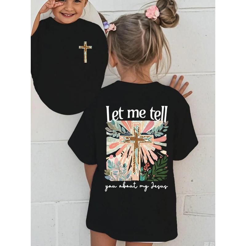 Colorful Graphic Black T-Shirt for Girls - Features Floral Cross Design and Inspirational 'Let me tell you about my Jesus' Text |   Adorned with Pink Hair Clips, Perfect for Casual Wear |   Stylish and Eye-Catching Top for Young Fashionistas