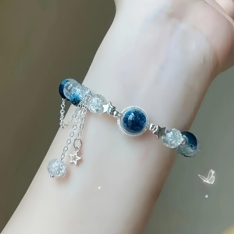 An elegant glass bead bracelet featuring a star pendant-a sophisticated, faux cat's-eye style accessory suitable for women and individuals aged 15 and up. Perfect for Valentine's Day, Carnival, and Christmas parties.