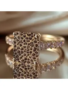 Leopard print square-shaped ring with wild pattern design. Side embellishments add a touch of flashiness, creating a cool and bold personalized ring.