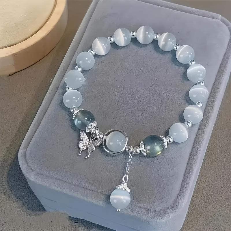 An elegant glass bead bracelet featuring a star pendant-a sophisticated, faux cat's-eye style accessory suitable for women and individuals aged 15 and up. Perfect for Valentine's Day, Carnival, and Christmas parties.