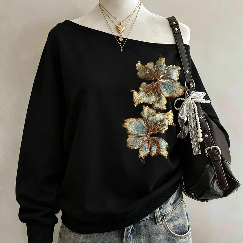 Fashionable off-shoulder black sweatshirt with luxurious gold floral embroidery, trendy and elegant casual street style, perfect for everyday gatherings, dates, weekend outings, and home wear #AutumnOutfit #OffShoulderTop #FloralEmbroideredSweatshirt