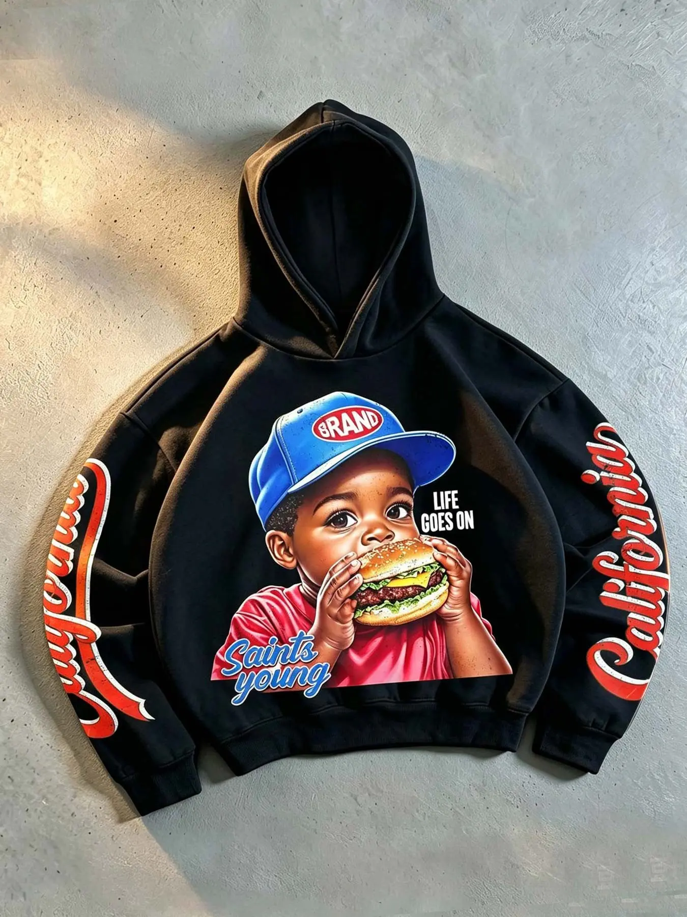 Men's/Unisex Los Angeles, California-themed hoodie featuring a graphic print of a child eating a donut; an American retro West Coast style sweatshirt with "California" lettering on the sleeve, fleece-lined, loose-fitting, and hip-hop inspired.