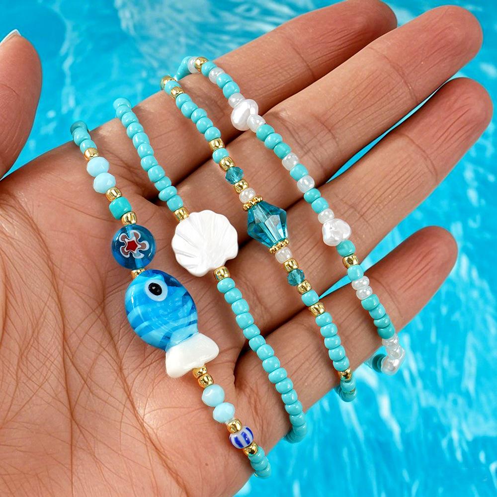 Niche & Whimsical Blue Glass Crystal Bracelet — Scallop Shell and Pearl-White Beaded Strand