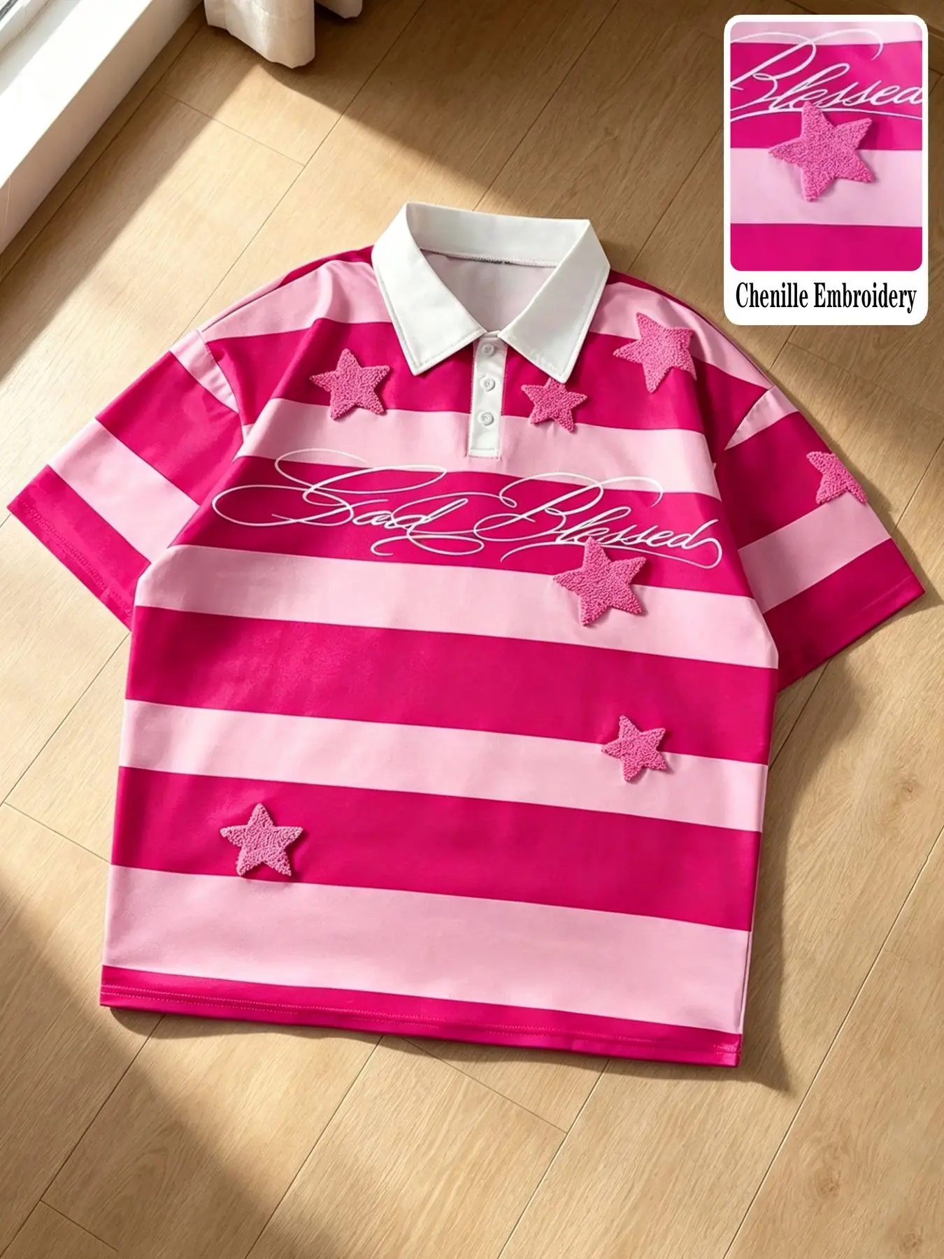 Unisex loose-fit Polo-collar short-sleeve T-shirt featuring a pink-and-white color-blocked striped design, star accents in towel embroidery, and "Sad Blessed" artistic script lettering; a versatile, everyday Classic casual piece in rose pink Menswear