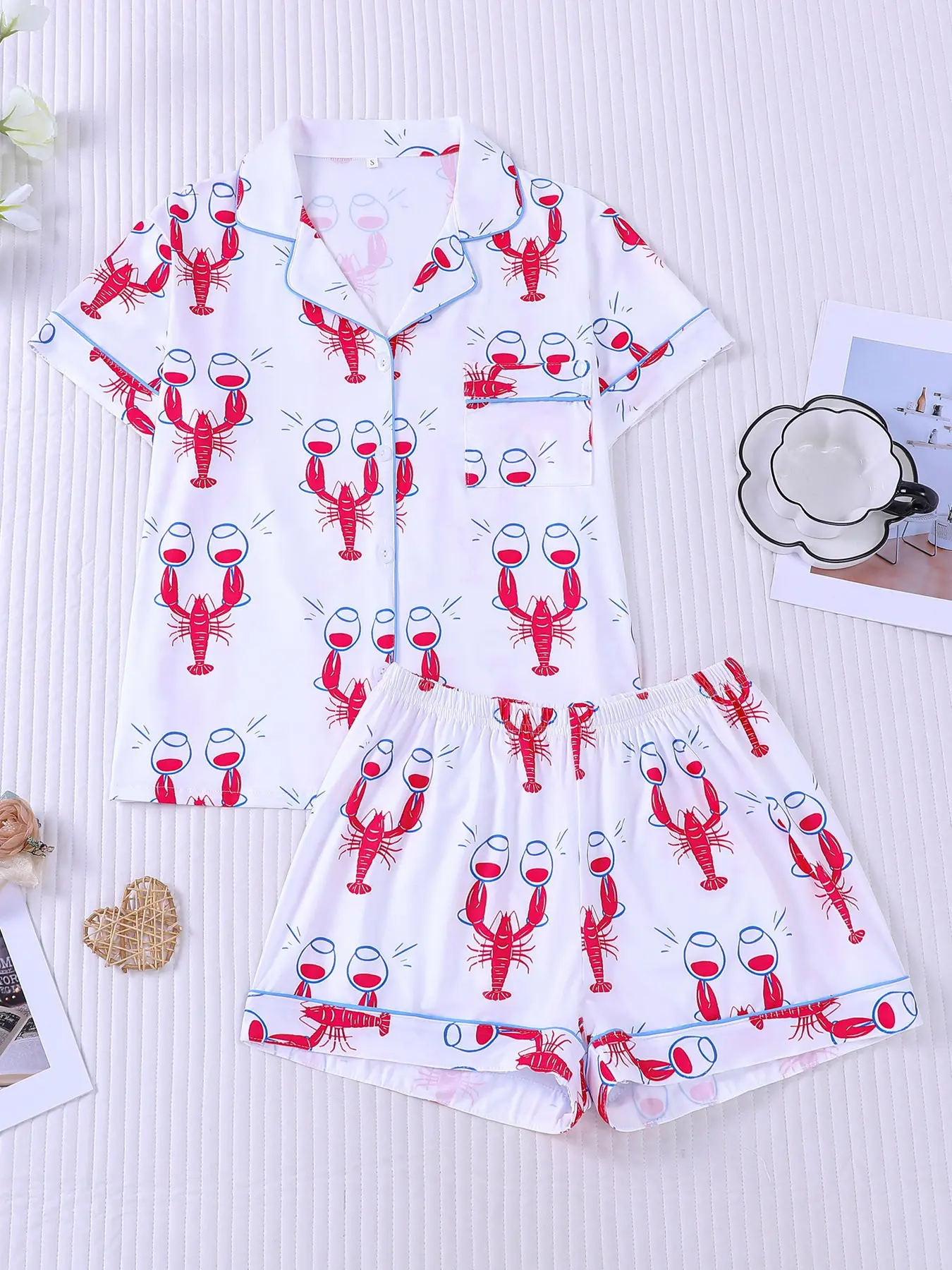 Women's 2-piece pajama set nightwear with fun red lobster & wine glass prints on white base, cute coastal party style, light blue contrast piping. Lapel top with pocket, soft elastic pajamas shorts, all-season casual loungewear for women