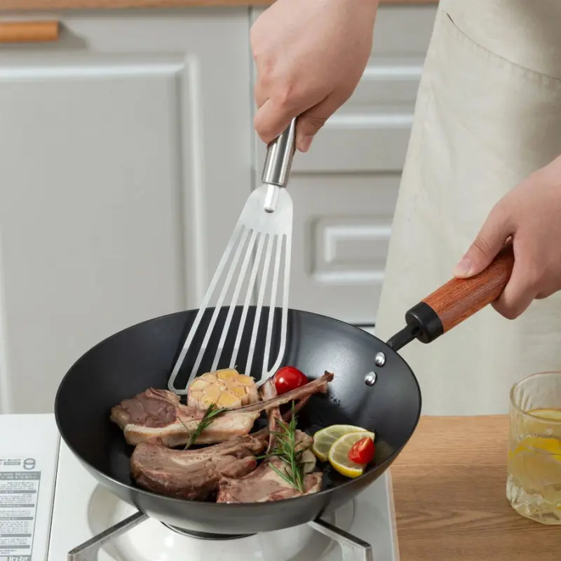 1 stainless steel frying spatula with heat-resistant handle, wide slot steak flipper, used for grilling, frying fish, and pancakes, a small kitchen cooking tool
