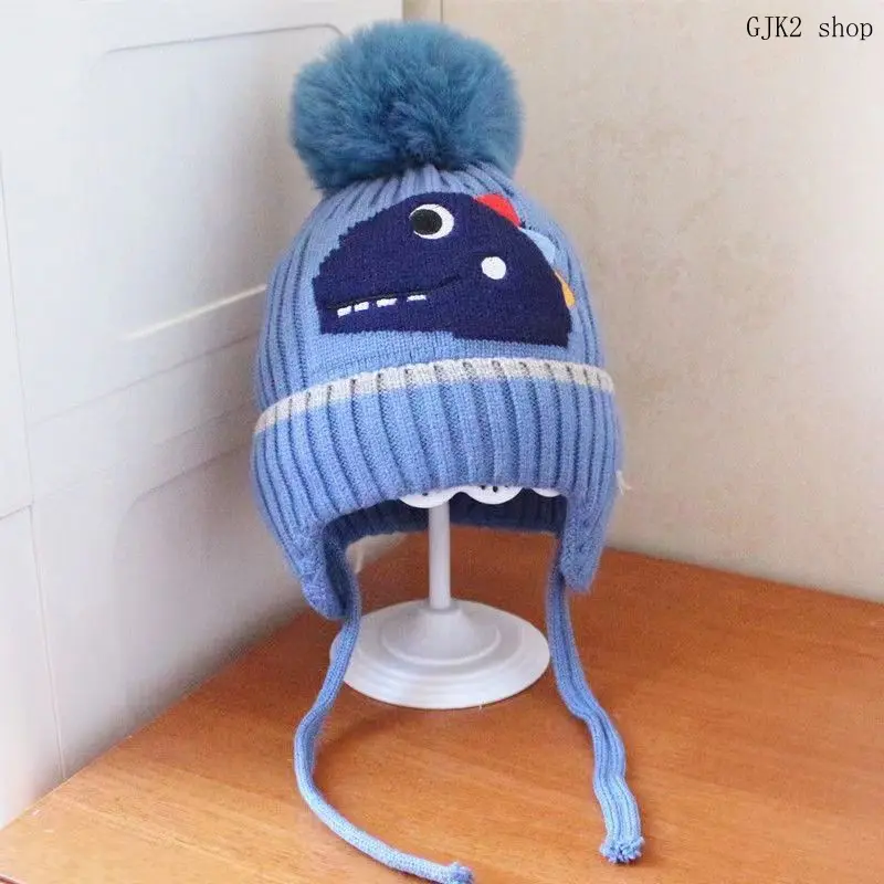 Soft knitted winter hat with pom‑poms and ear protection, keeps kids warm in cold weather. Suitable for boys and girls.