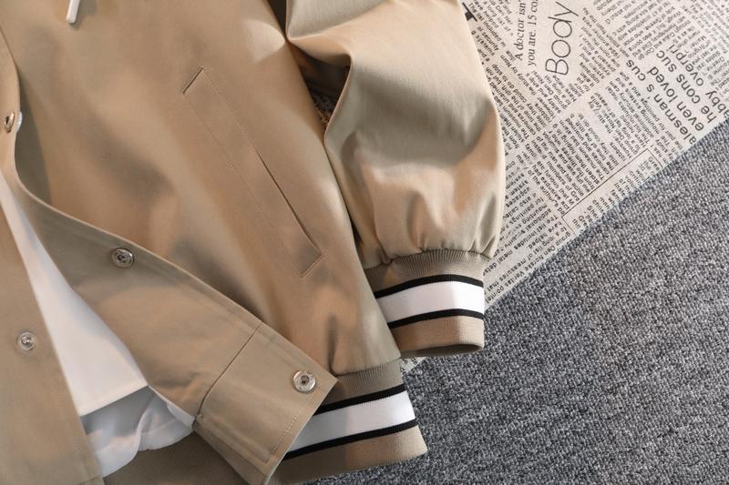 A hooded letter jacket, featuring a casual and simple style. The hooded design is sleek and elegant, while the overall design is practical and versatile. The letter embroidery adds a touch of sophistication, and the striped accent at the cuffs completes t A hooded letter jacket, featuring a casual and simple style. The hooded design is sleek and elegant, while the overall design is practical and versatile. The letter embroidery adds a touch of sophistication, and the striped accent at the cuffs completes t