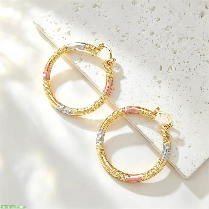 A pair of stylish, two-tone twisted hoop earrings; crafted from 14K gold-plated copper and suitable for both men and women—an ideal choice for a birthday or wedding gift.
