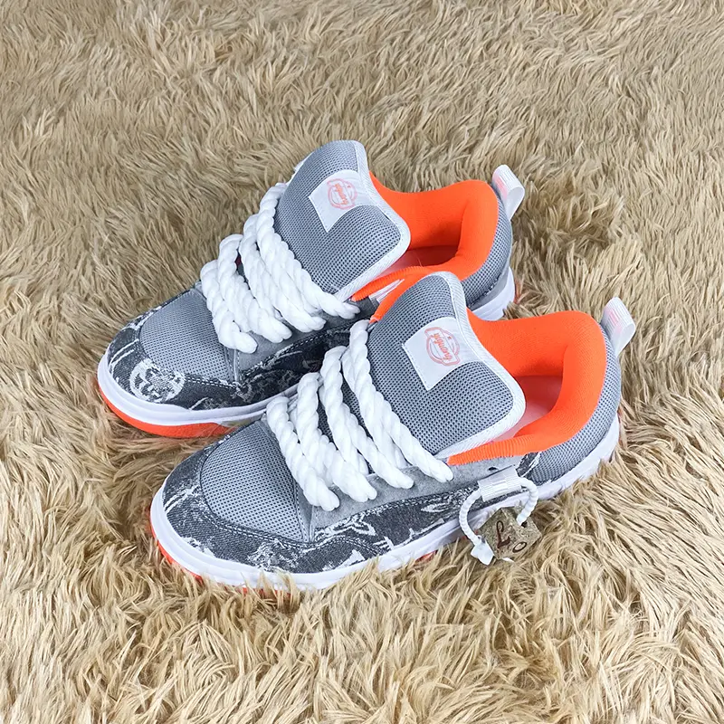 Grey Mesh Vintage Graffiti Print Platform Skate Sneakers for Men and Women, with Chunky White Twisted Rope Laces and Bright Orange Lining & Outsole. Featuring a Wooden Lock Tag, these retro Y2K hip-hop low-top casual board shoes are perfect for skateboard