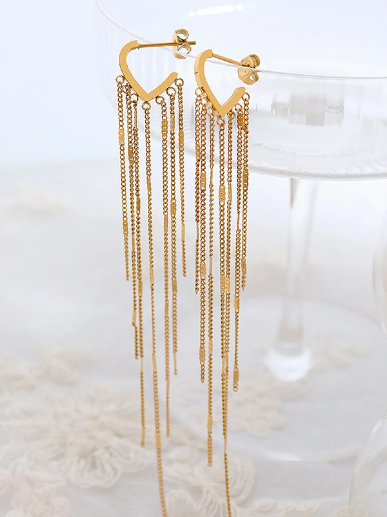 A stylish heart-shaped hollowed-out sequin long pendant earrings with cascading fringe that enhances facial features and naturally shines, perfect for evening parties, music festivals, weddings, and atmospheric street photography.