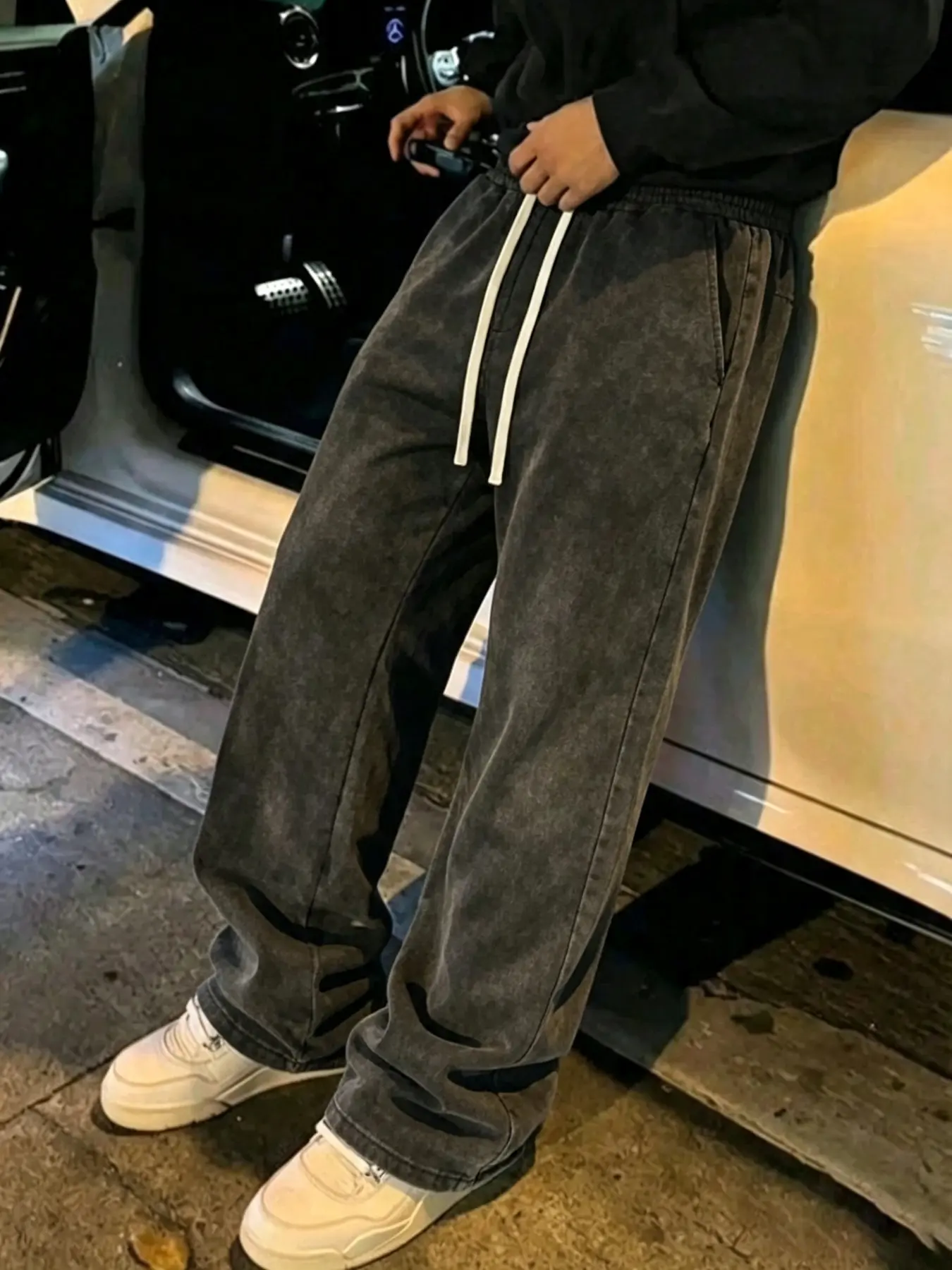 Men's sweatpants featuring a washed, distressed finish and cotton fabric; designed with a slight flare cut, these Loose, lightweight, casual pants offer a versatile, essential style.