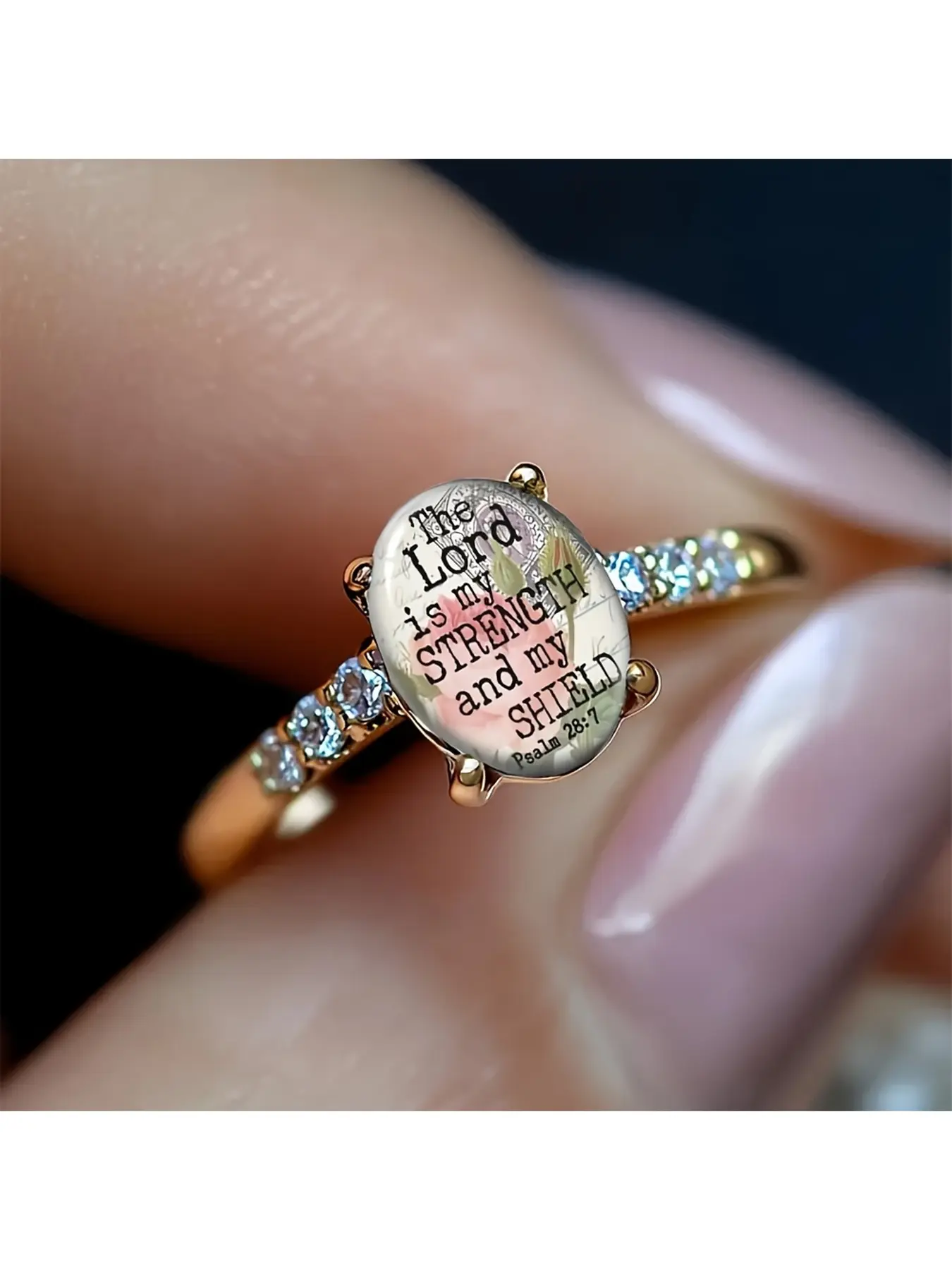 A rose gold ring with a pale background and pink rose pattern, engraved with the scripture "The Lord is my strength and my shield", from Psalm 28:7. It symbolizes that the Lord is my strength and my shield. This vintage and gentle design is suitable as a